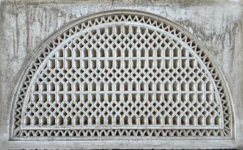 Arched gypsum screen with pierced lattice